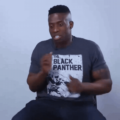 A Man Is Wearing A T-Shirt That Says The Black Panther On It GIF