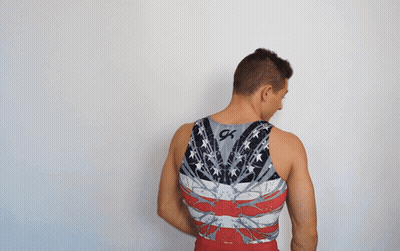 A Man Is Wearing A Tank Top With The Letter K On It GIF