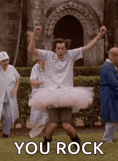 A Man Is Wearing A Tutu And Dancing In A Park With A Group Of People . GIF