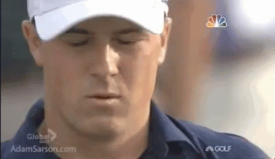 A Man Is Wearing A White Hat And A Blue Shirt . GIF