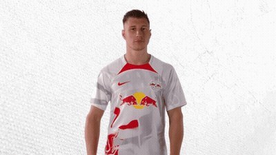A Man Is Wearing A White Shirt With A Red Bull On It GIF