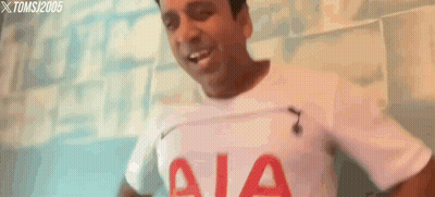A Man Is Wearing A White Shirt With Aia On It GIF