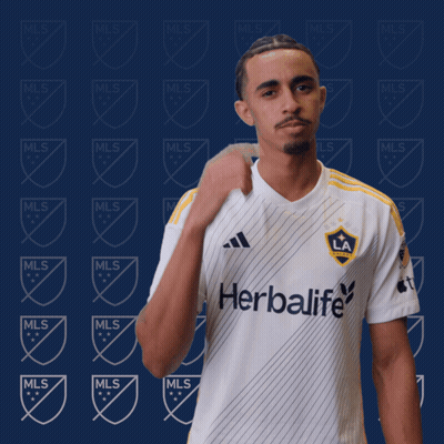 A Man Is Wearing A White Shirt With The Word Herbalife On It GIF