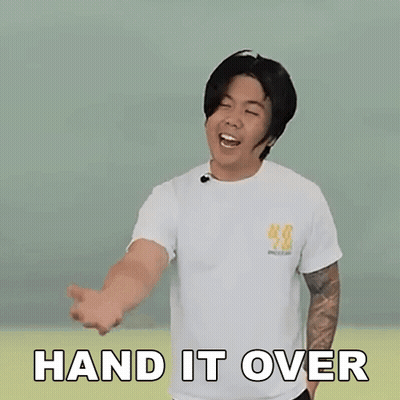 A Man Is Wearing A White T-Shirt And Making A Hand Gesture With The Words Hand It Over Written On It . GIF