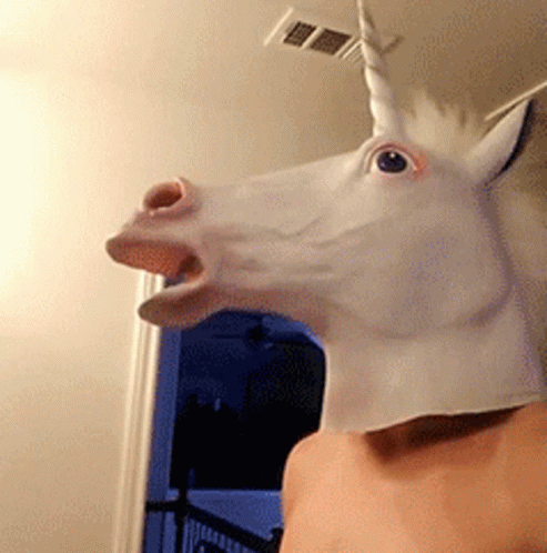 A Man Is Wearing A White Unicorn Mask GIF