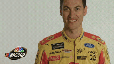 A Man Is Wearing A Yellow And Red Nascar Jersey GIF