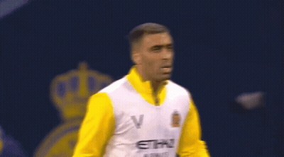 A Man Is Wearing A Yellow And White Etihad Airways Jersey GIF
