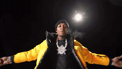A Man Is Wearing A Yellow Jacket And A Black Beanie GIF