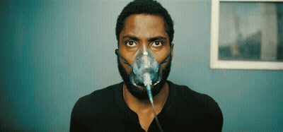 A Man Is Wearing An Oxygen Mask On His Face GIF
