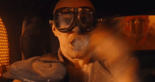 A Man Is Wearing Goggles And Smoking A Cigarette GIF