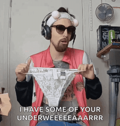 A Man Is Wearing Headphones And Holding A Pair Of Underwear . GIF