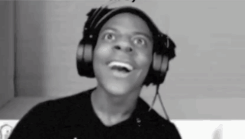 A Man Is Wearing Headphones And Making A Funny Face . GIF