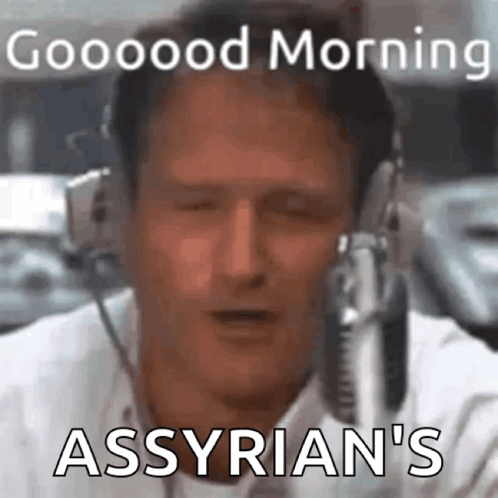 A Man Is Wearing Headphones And Talking Into A Microphone . GIF
