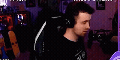 A Man Is Wearing Headphones While Sitting In A Chair . GIF