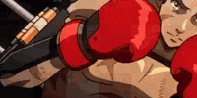 A Man Is Wearing Red Boxing Gloves And Holding A Gun In His Hand . GIF