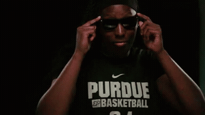 A Man Is Wearing Sunglasses And A Purdue Basketball Shirt GIF