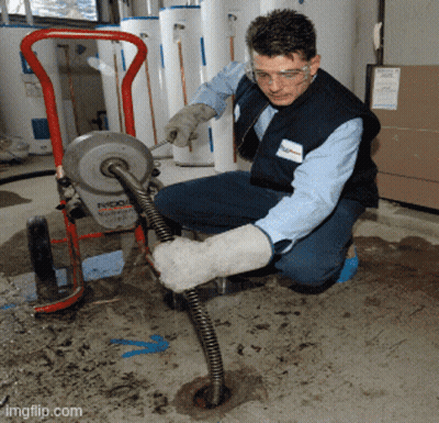 A Man Is Working On A Machine That Says Ridgid GIF