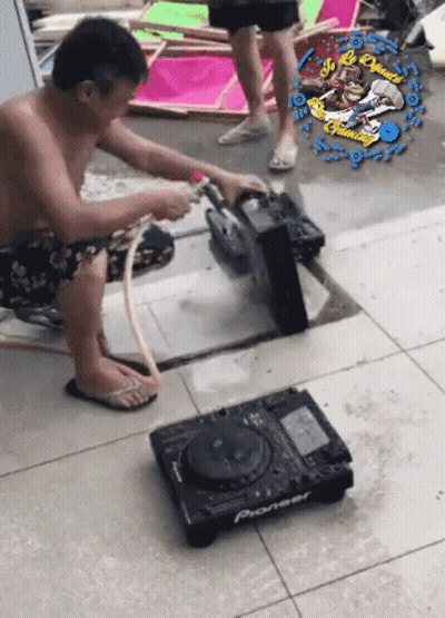 A Man Is Working On A Pioneer Dj Setup GIF