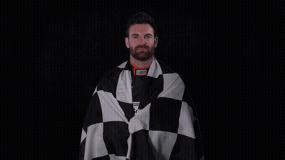A Man Is Wrapped In A Black And White Checkered Cloth GIF