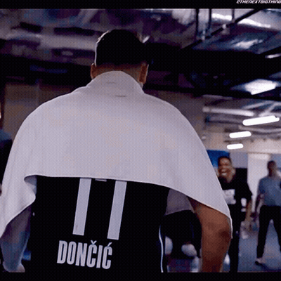 A Man Is Wrapped In A Towel And Has The Name Doncic On His Shirt GIF