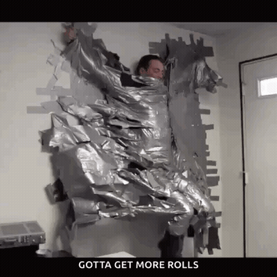 A Man Is Wrapped In Duct Tape And Says Gotta Get More Rolls On The Bottom . GIF