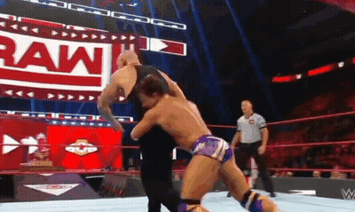 A Man Is Wrestling Another Man In A Wrestling Ring . GIF