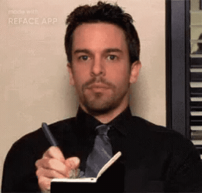 A Man Is Writing In A Notebook With A Pen . GIF