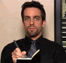 A Man Is Writing In A Notebook With A Pen GIF