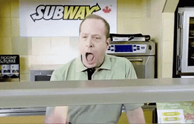 A Man Is Yawning In Front Of A Sign That Says Subway GIF