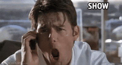 A Man Is Yawning While Talking On A Cell Phone In A Movie . GIF