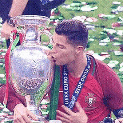A Man Kisses A Trophy That Says Euro 2016 On It GIF