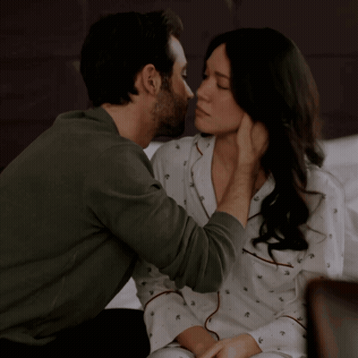 A Man Kisses A Woman On The Forehead While She Looks On GIF