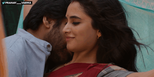 A Man Kisses A Woman On The Forehead With The Hashtag Pranay_varma On The Bottom GIF