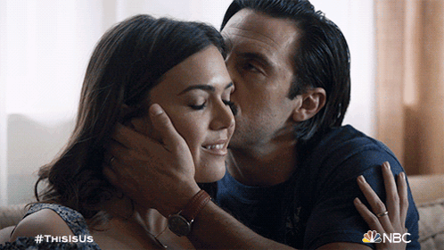 A Man Kisses A Woman On The Forehead With The Hashtag #Thisisus GIF