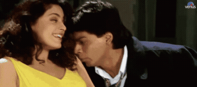 A Man Kissing A Woman On The Cheek With Venus Written On The Bottom GIF