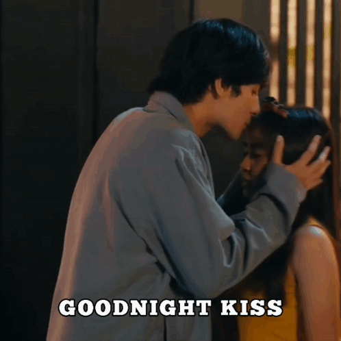 A Man Kissing A Woman 'S Forehead With The Words Goodnight Kiss Above Them GIF