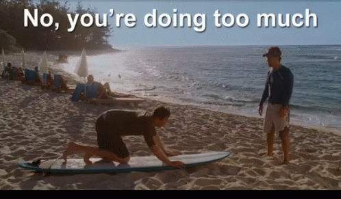 A Man Kneeling On A Surfboard On A Beach With The Words " No You 'Re Doing Too Much " GIF