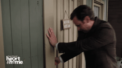 A Man Knocks On A Door With A Sign That Says Mayor Hotkam On It GIF