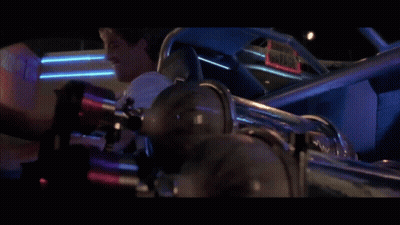 A Man Laughs While Sitting In A Car With A Sign That Says Gator GIF