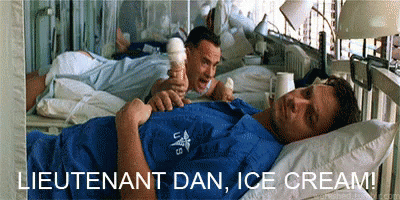 A Man Laying In A Hospital Bed Eating Ice Cream GIF