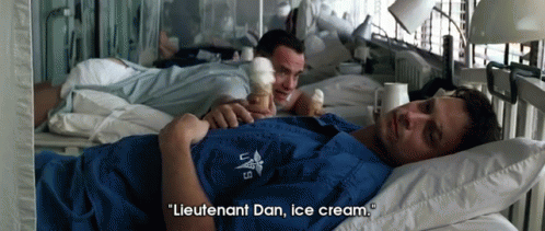 A Man Laying In A Hospital Bed With The Words " Lieutenant Dan Ice Cream " Above Him GIF