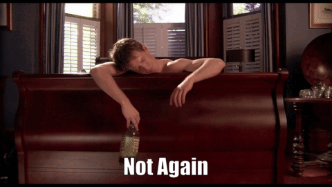 A Man Laying On A Bed With A Bottle Of Liquor And The Words Not Again Behind Him GIF