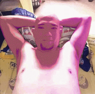 A Man Laying On A Bed With His Arms Behind His Head GIF