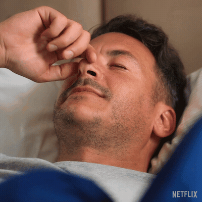 A Man Laying On A Bed With His Eyes Closed And A Netflix Logo In The Corner GIF