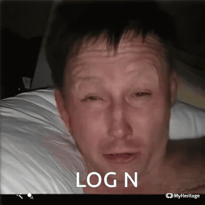 A Man Laying On A Bed With His Eyes Closed And The Words Log N Written On The Bottom GIF