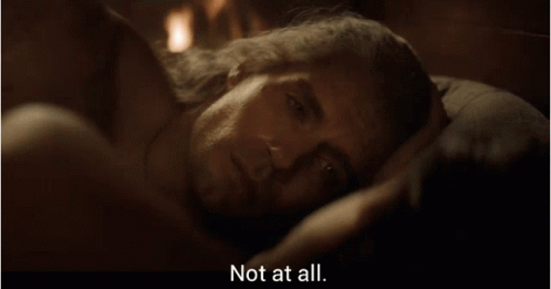 A Man Laying On A Bed With The Words " Not At All " Next To Him GIF