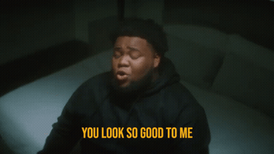 A Man Laying On A Bed With The Words You Look So Good To Me Below Him GIF