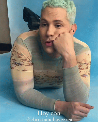 A Man Laying On A Blue Surface With The Caption Hoy Con @Christianchavezreal GIF