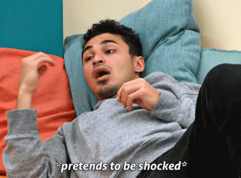 A Man Laying On A Couch With The Words Pretends To Be Shocked GIF