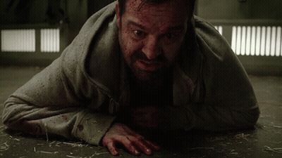 A Man Laying On The Floor With Blood On His Face And Hands GIF